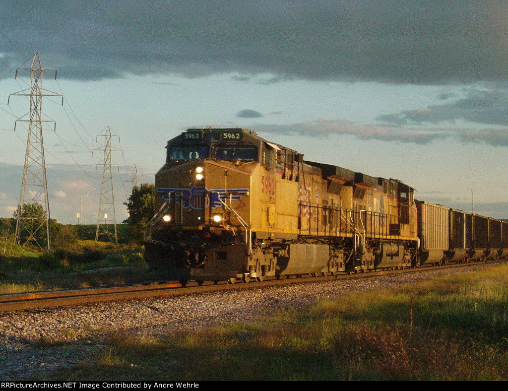 UP 5962 leads Weston coal loads at Ryan Road under a post-storm sky